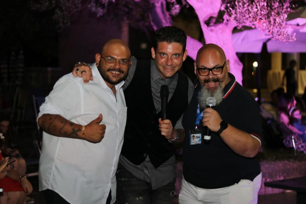 a group of men posing for a picture at a party at Corvino Resort in Monopoli