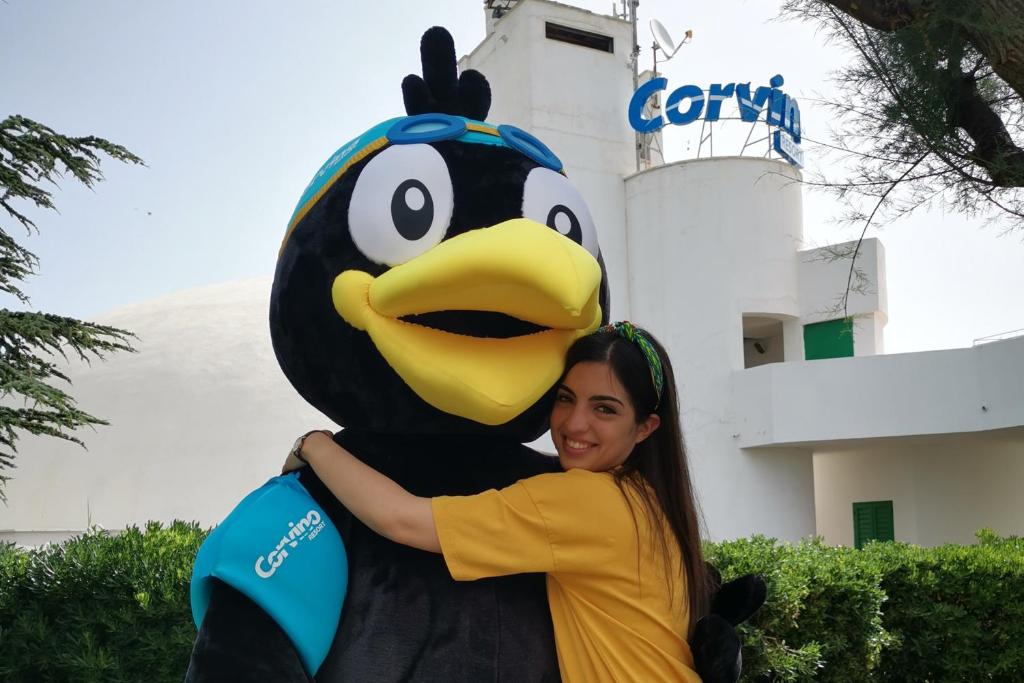 a woman holding a large rubber duck mascot at Corvino Resort in Monopoli