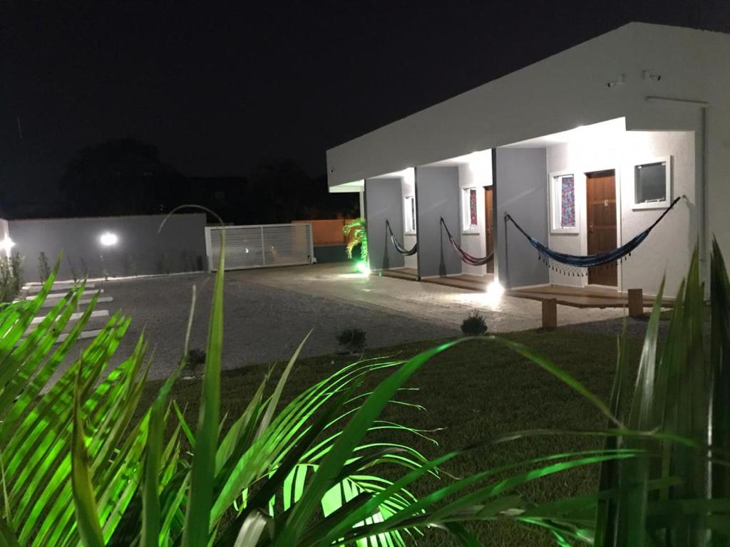 a building with a bench in front of it at night at Florianópolis Pousada Moçambeach in Florianópolis