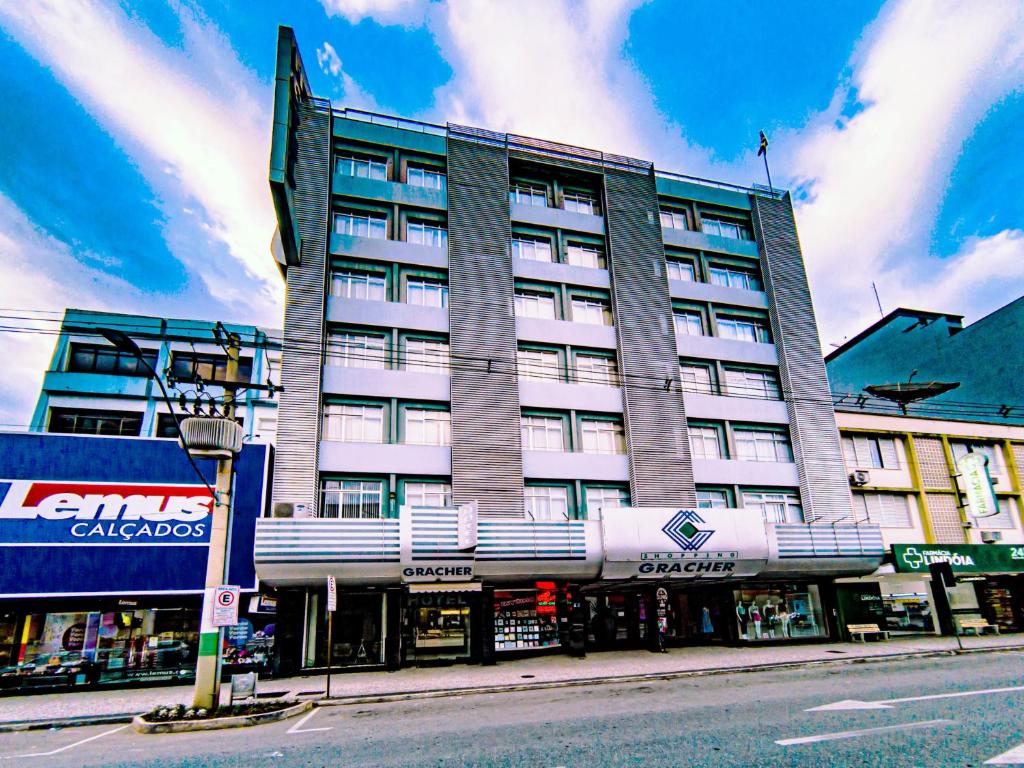 a large building on a city street with at Hotel Gracher Brusque in Brusque