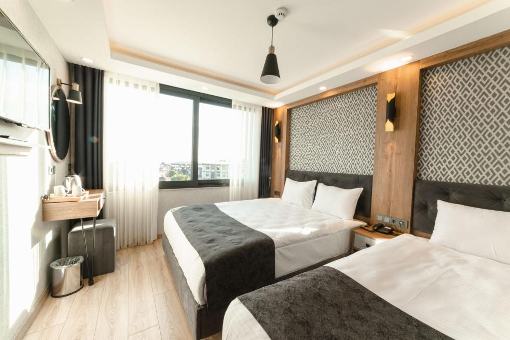 a hotel room with two beds and a window at World Heritage Center Hotel in Istanbul