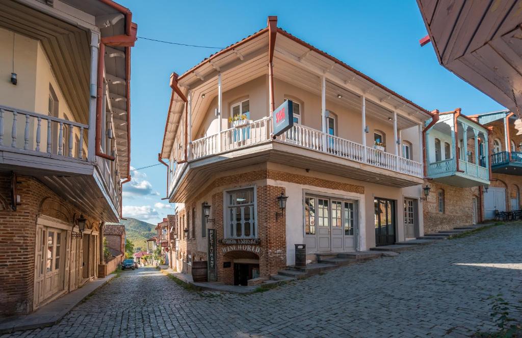 a street in an old town with a building at Hotel History • სასტუმრო ისტორია in Sighnaghi