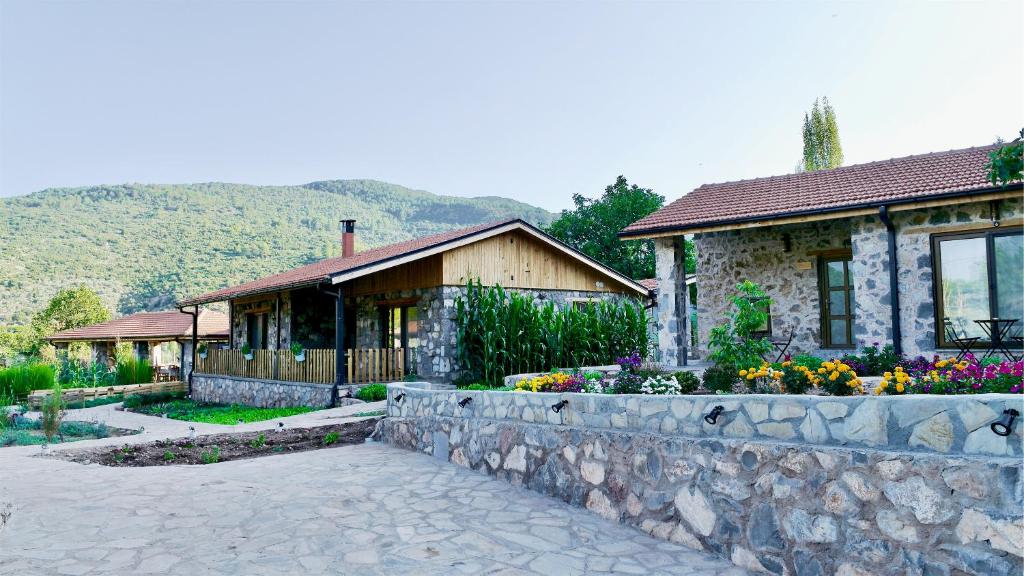 a house with a stone wall in front of it at Dedehan Retreat Otel in Muğla