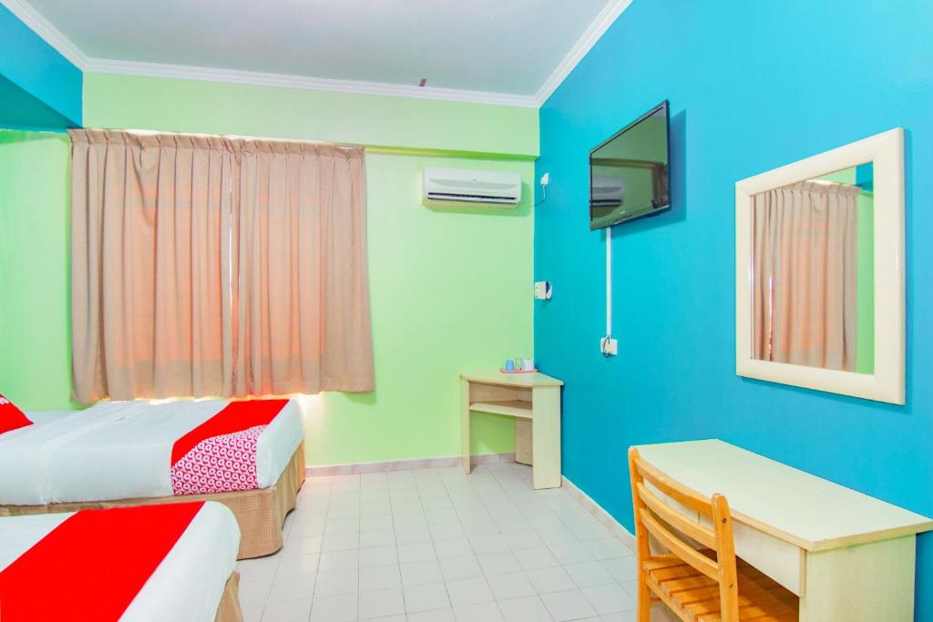 Postel nebo postele na pokoji v ubytování Super OYO 1159 Hotel New Sabah