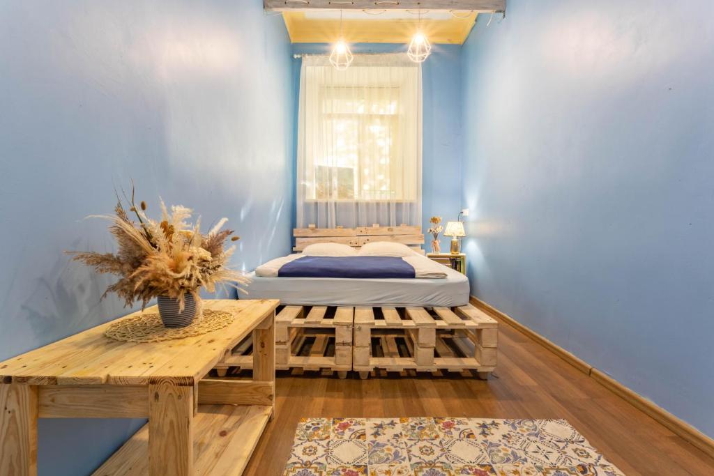 a small room with a bed and a table at FACTORY Hostel in Kyiv