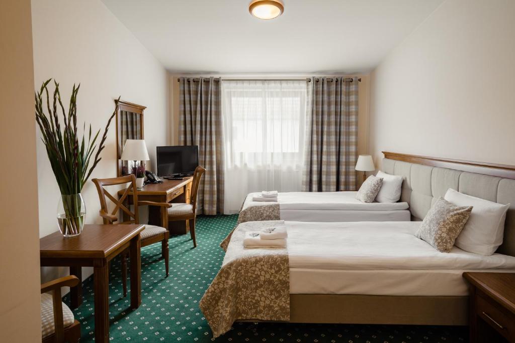 Postel nebo postele na pokoji v ubytování Hotel Ranczo Smyczyna