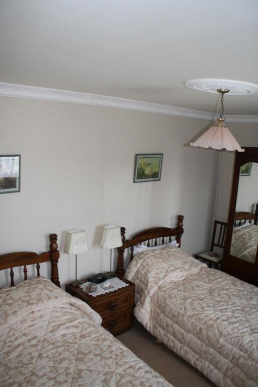 Postel nebo postele na pokoji v ubytování Moate Lodge