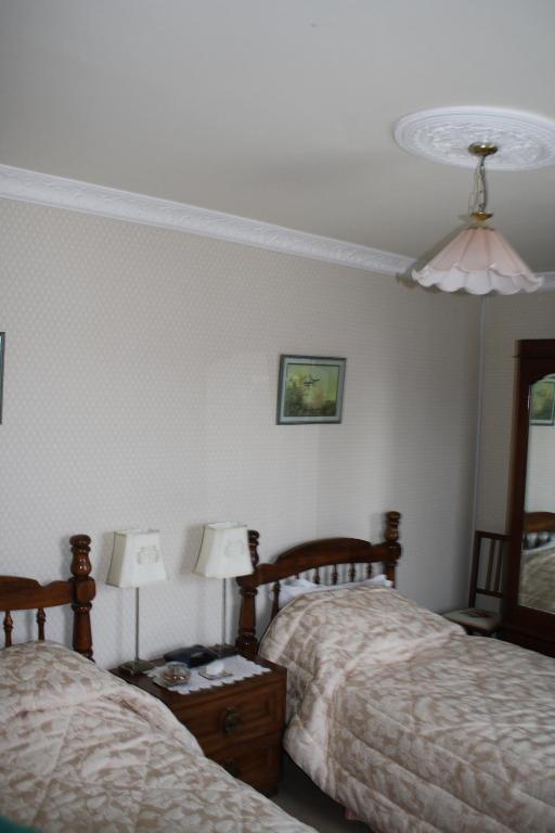 Postel nebo postele na pokoji v ubytování Moate Lodge