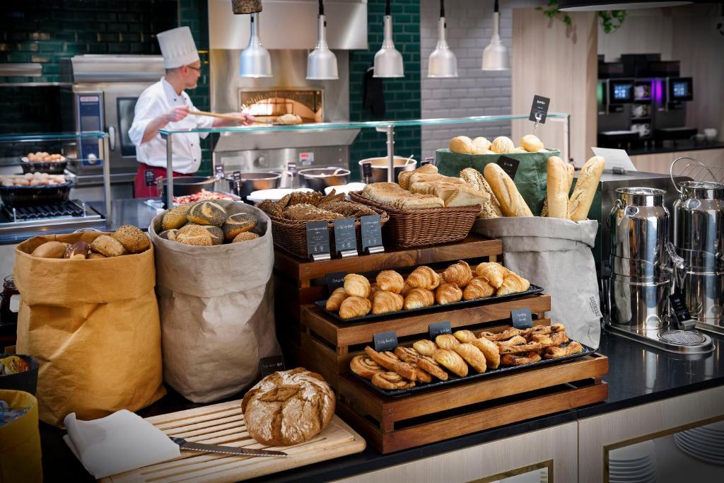 a bakery with bread and pastries on a counter at Crowne Plaza Berlin City Centre Ku'damm, an IHG Hotel in Berlin