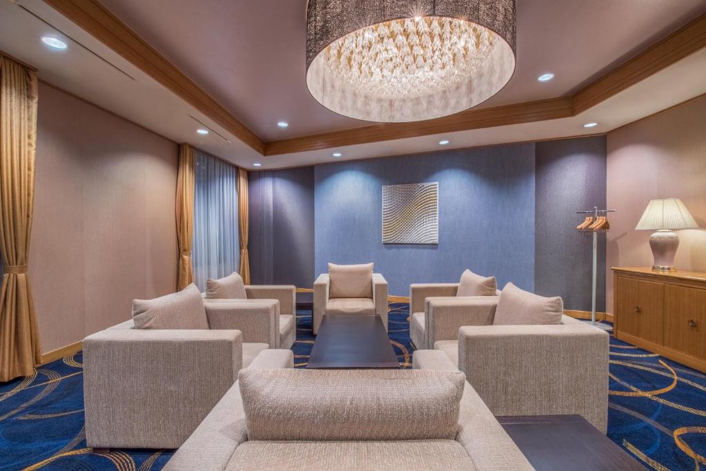 a waiting room with chairs and a chandelier at ANA Crowne Plaza Kanazawa by IHG in Kanazawa