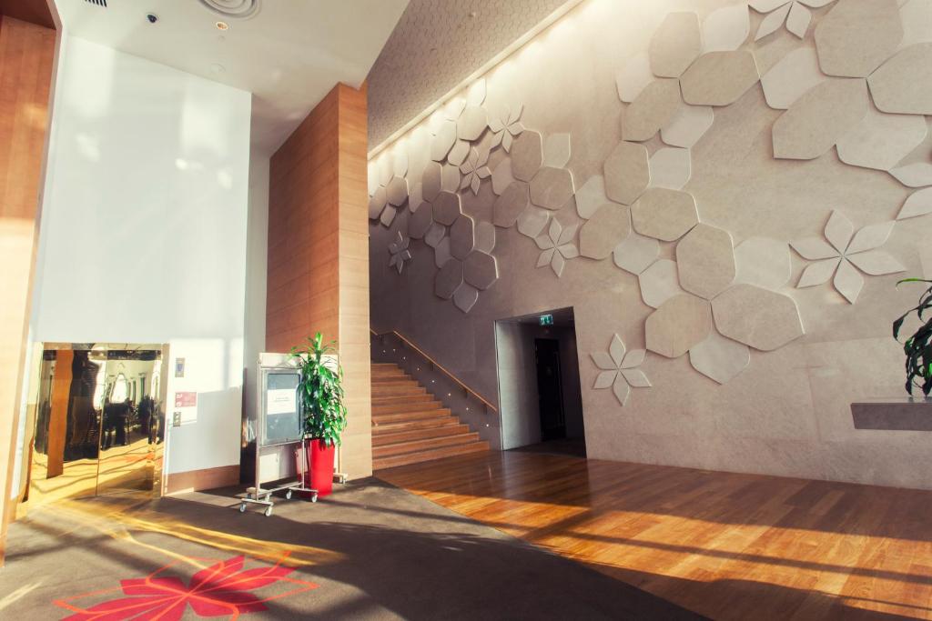 a lobby with a wall with a flower design on it at Crowne Plaza Yas Island by IHG in Abu Dhabi