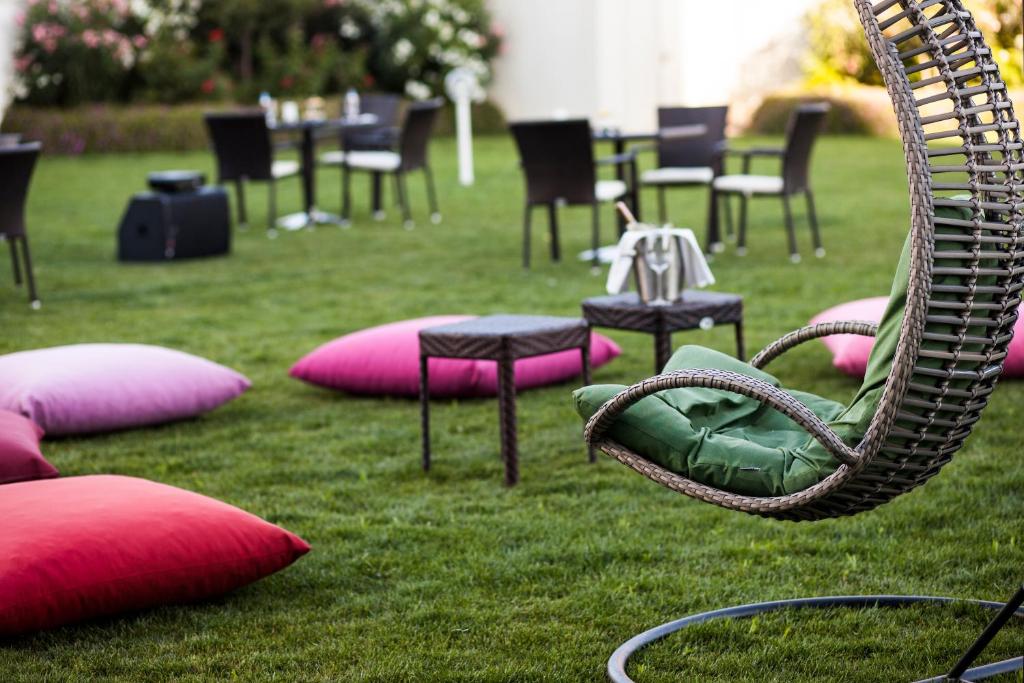 a swing in the grass with chairs and tables at Crowne Plaza Istanbul Oryapark by IHG in Istanbul