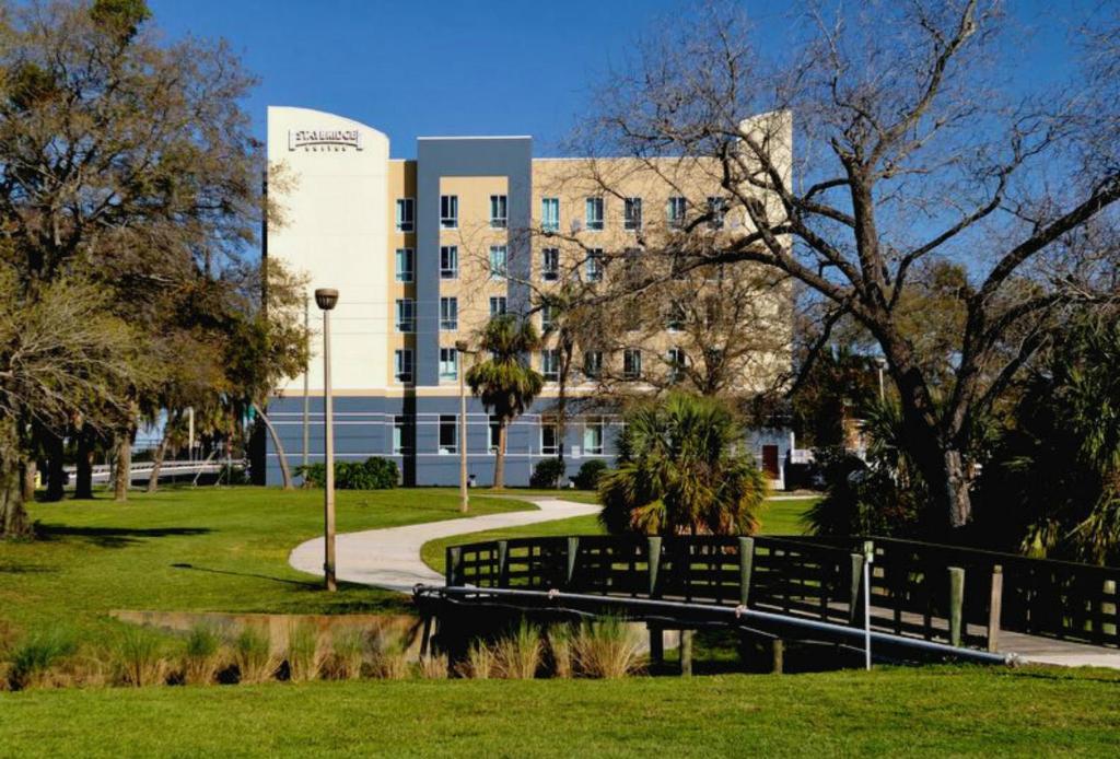 a campus with a bridge in front of a building at Staybridge Suites St. Petersburg FL, an IHG Hotel in St. Petersburg