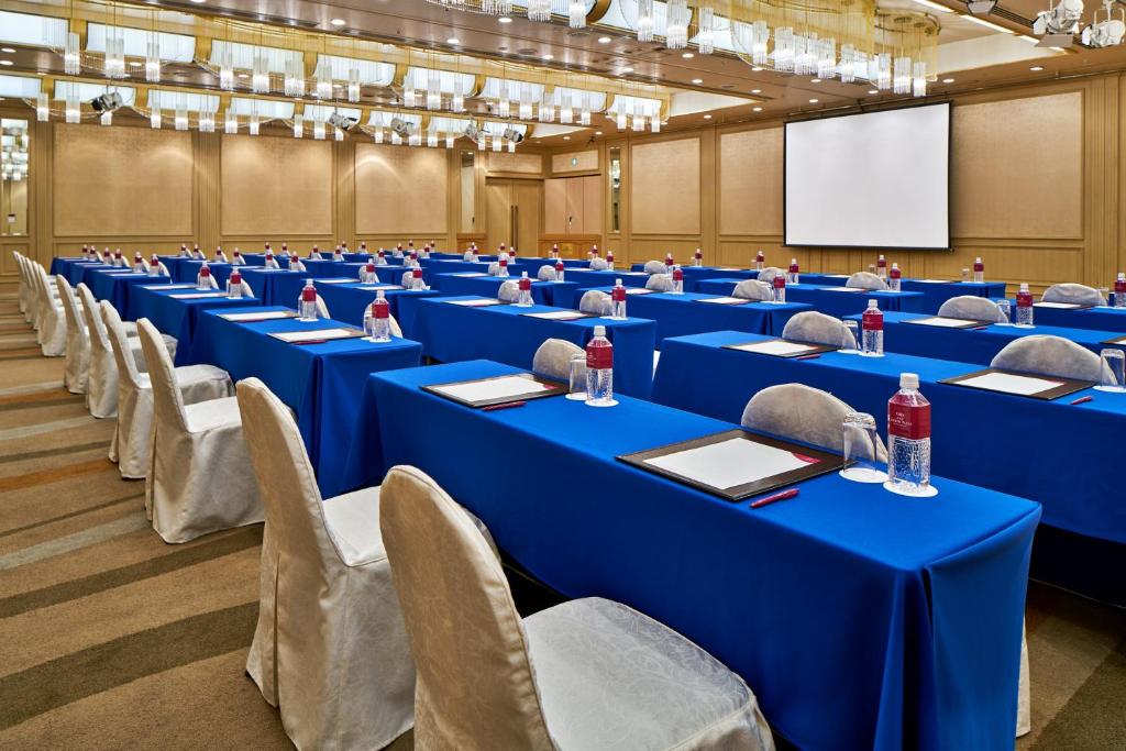 a conference room with blue tables and chairs and a screen at ANA Crowne Plaza Hotel Kyoto by IHG in Kyoto