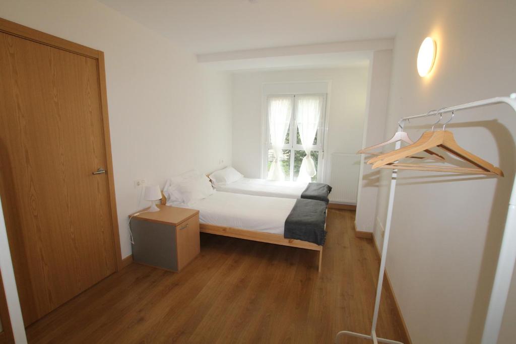 a small bedroom with a bed and a window at APARTAMENTO LABEGAIN 2 in Sestao
