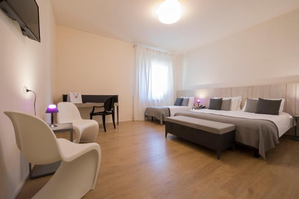 Postel nebo postele na pokoji v ubytování Hotel La Corte