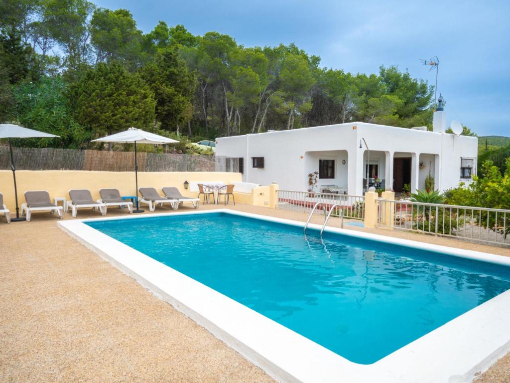 a swimming pool in front of a house at Holiday Home Can Fulgencio II by Interhome in Cala Llena