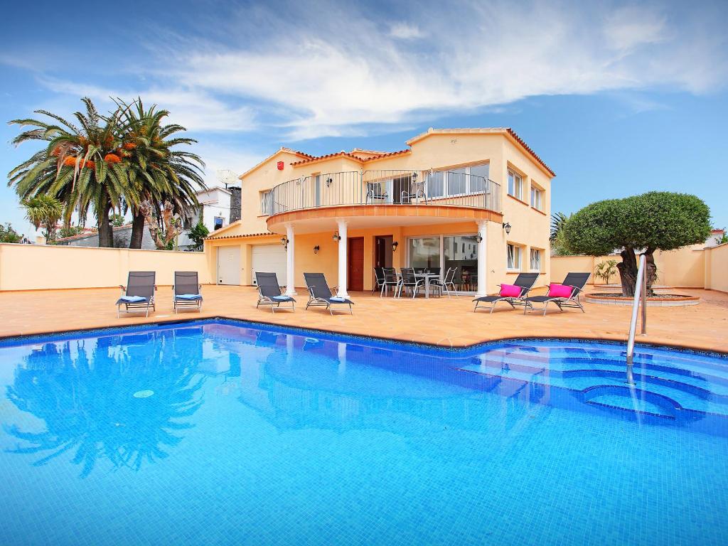 a large swimming pool in front of a house at Holiday Home Requesens by Interhome in Empuriabrava