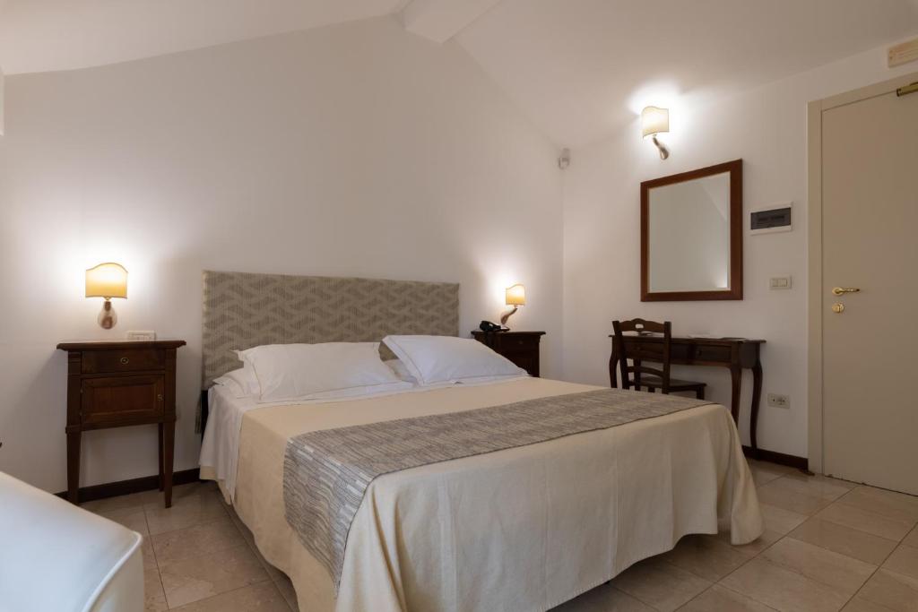 Postel nebo postele na pokoji v ubytování Hotel La Terra