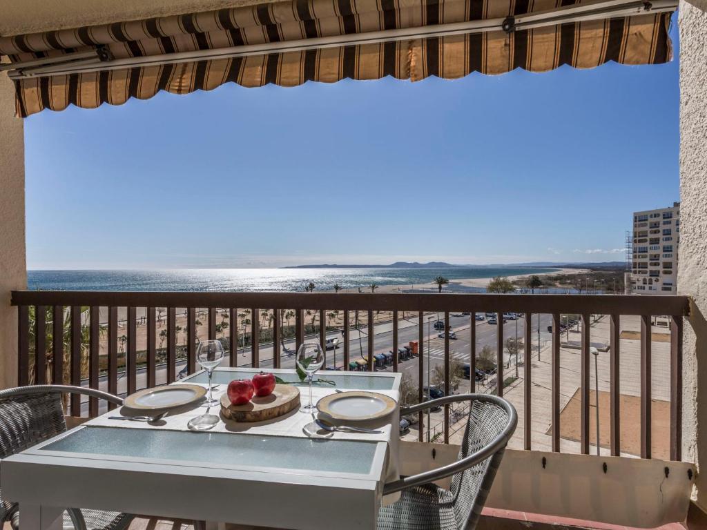 a table and chairs on a balcony with a view of the beach at Apartment Canigó by Interhome in Empuriabrava