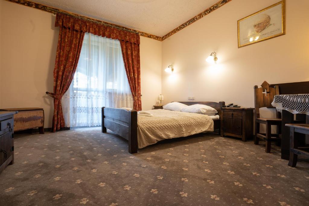 Postel nebo postele na pokoji v ubytování Hotel Trylogia