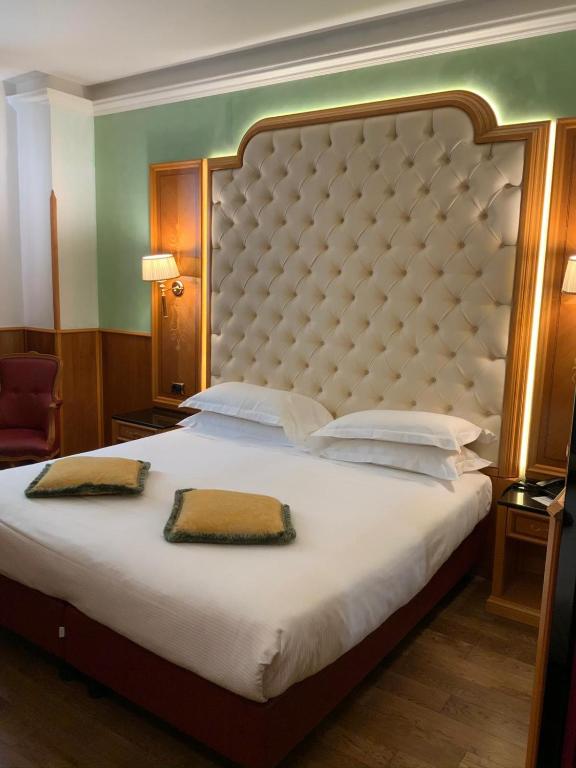 Postel nebo postele na pokoji v ubytování Hotel Vittoria