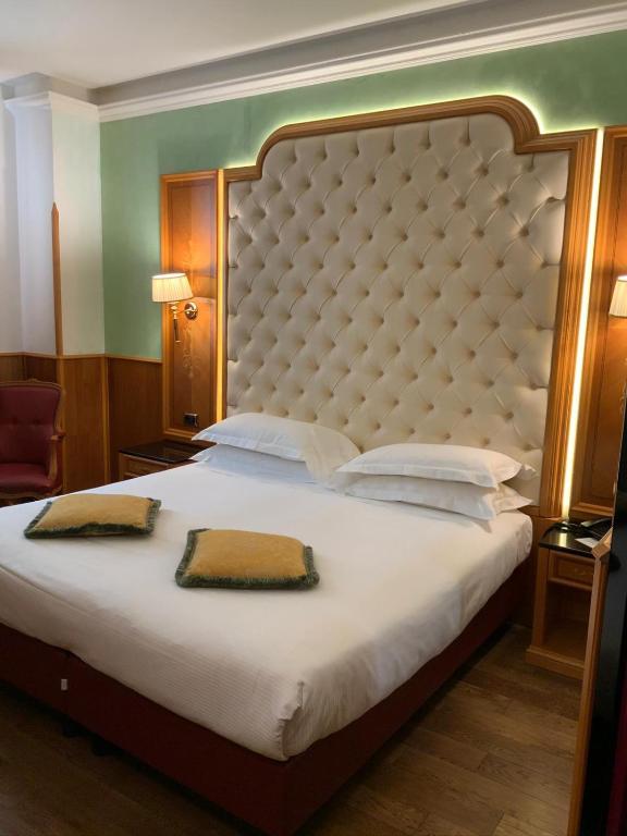 Postel nebo postele na pokoji v ubytování Hotel Vittoria
