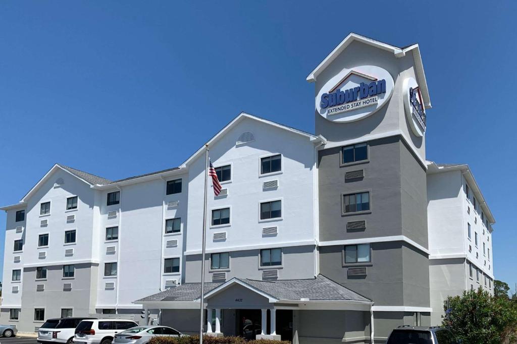 a hotel with a sign on the front of it at Suburban Studios near Panama City Beach in Panama City