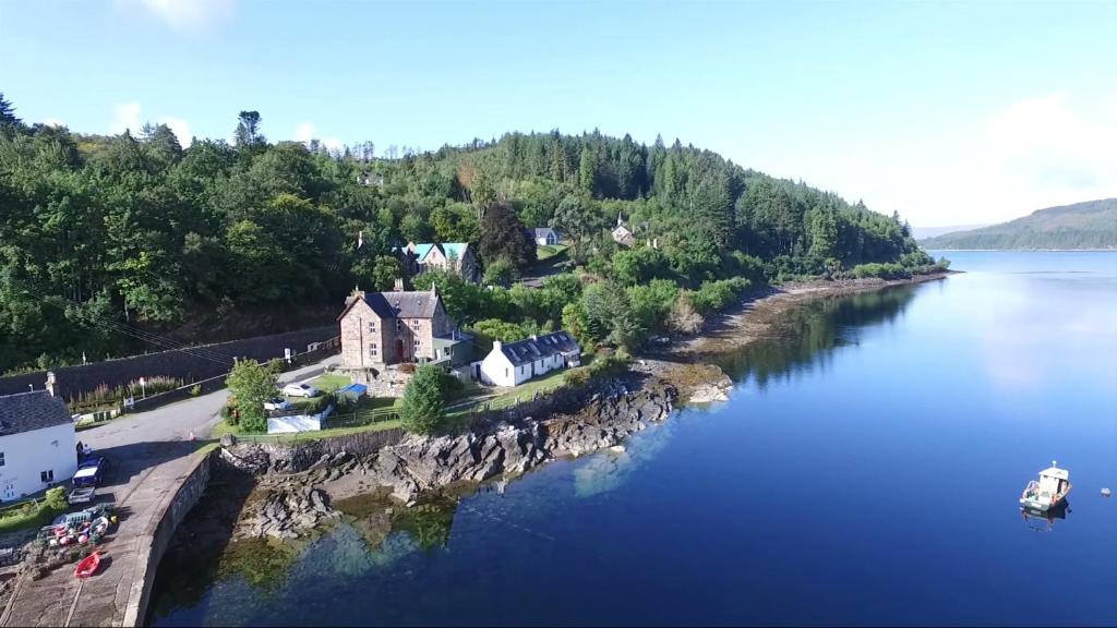 an aerial view of a house on an island in the water at Stationmasters Lodge in Stromeferry