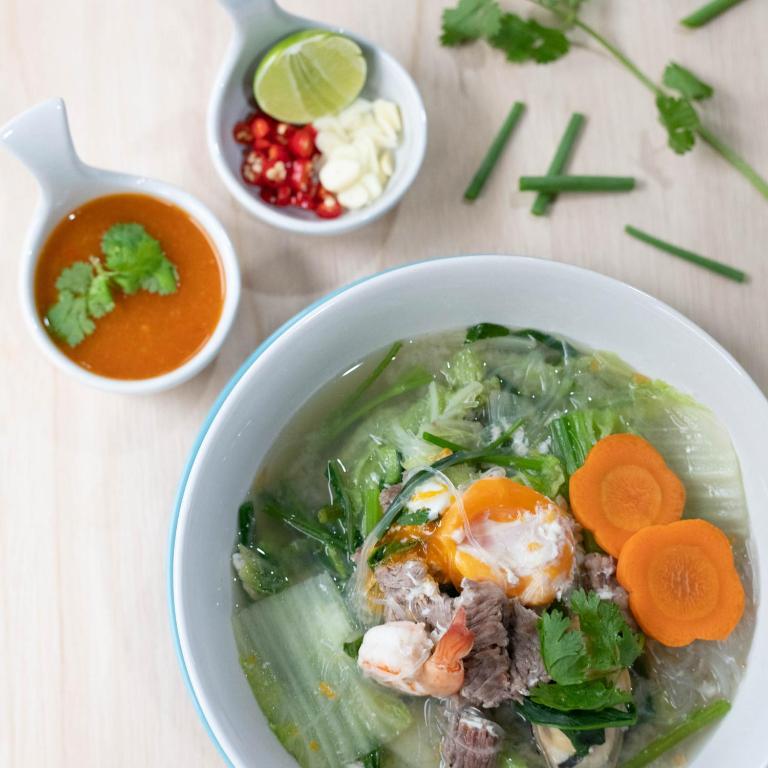 a bowl of soup with meat and vegetables and carrots at Montree Phuket Hotel in Phuket Town