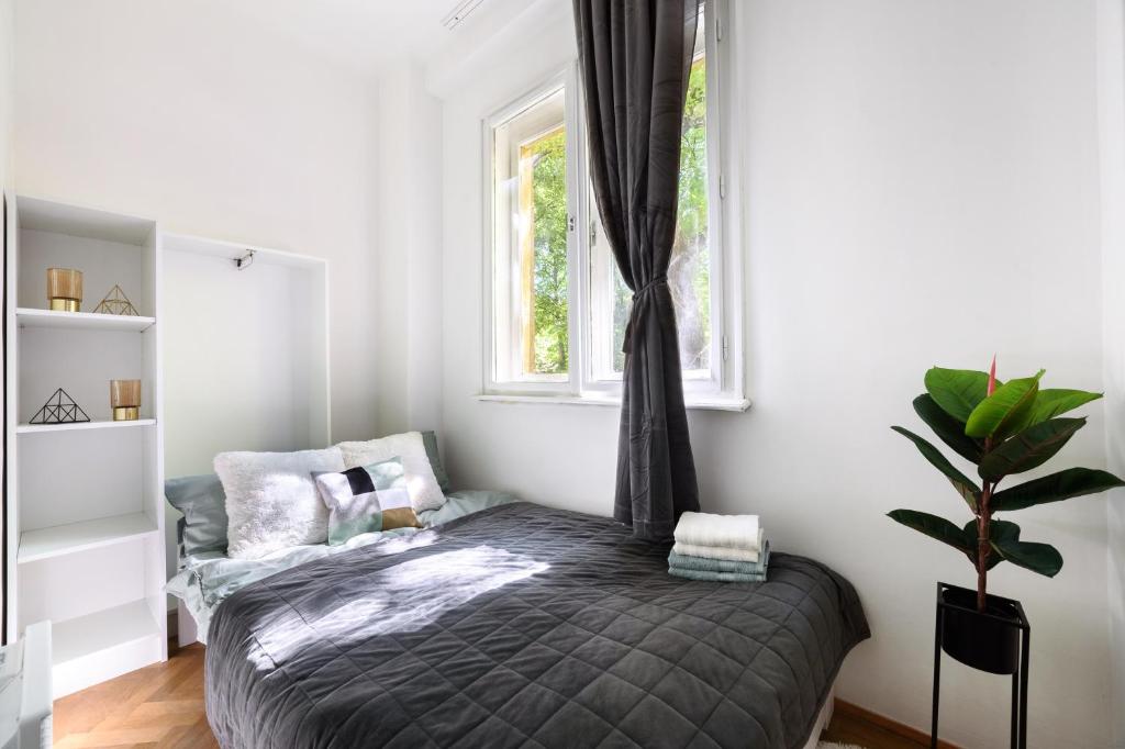 a bedroom with a bed and a window at Buda Centre Homes by the Allee Shopping Mall in Budapest