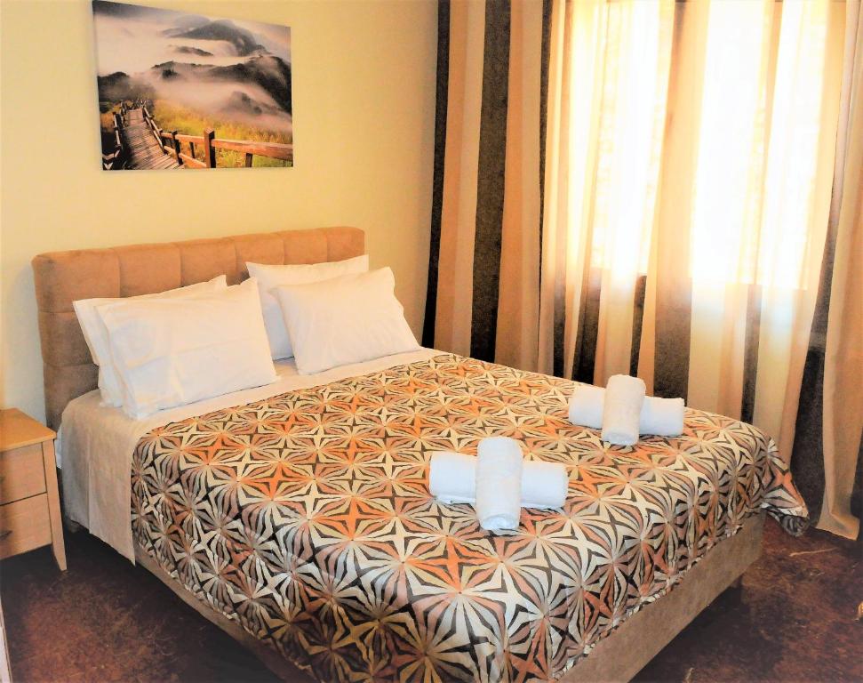 a bedroom with a bed with two candles on it at Delphic Horizons in Delphi