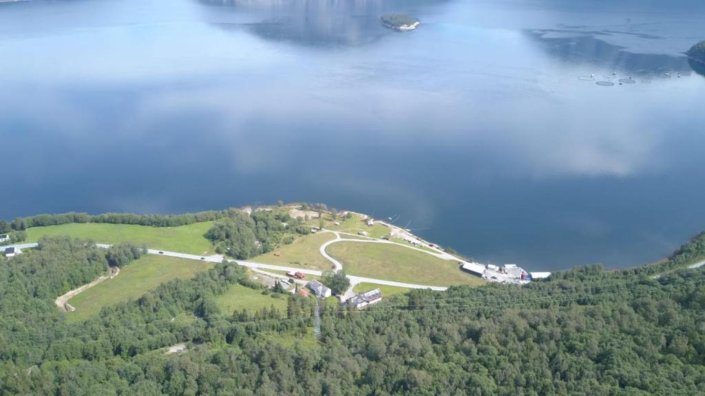 an island in the middle of a body of water at Sunndalsfjord Cottages Fredsvik Meisalstranda 455,506 og 508 in Sunndalsøra