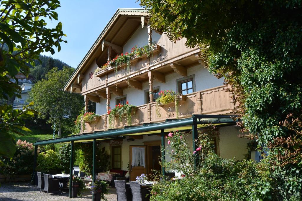 a building with flower boxes on the side of it at Der Waidachhof Zillertal in Hainzenberg