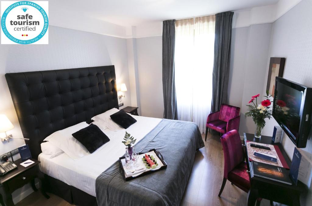 a hotel room with a bed and a desk at La Casa de la Trinidad in Granada