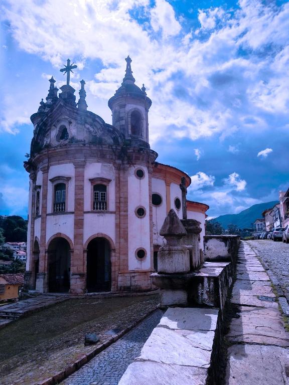 an old church with a cross on top of it at º Real Central Suite º in Ouro Preto