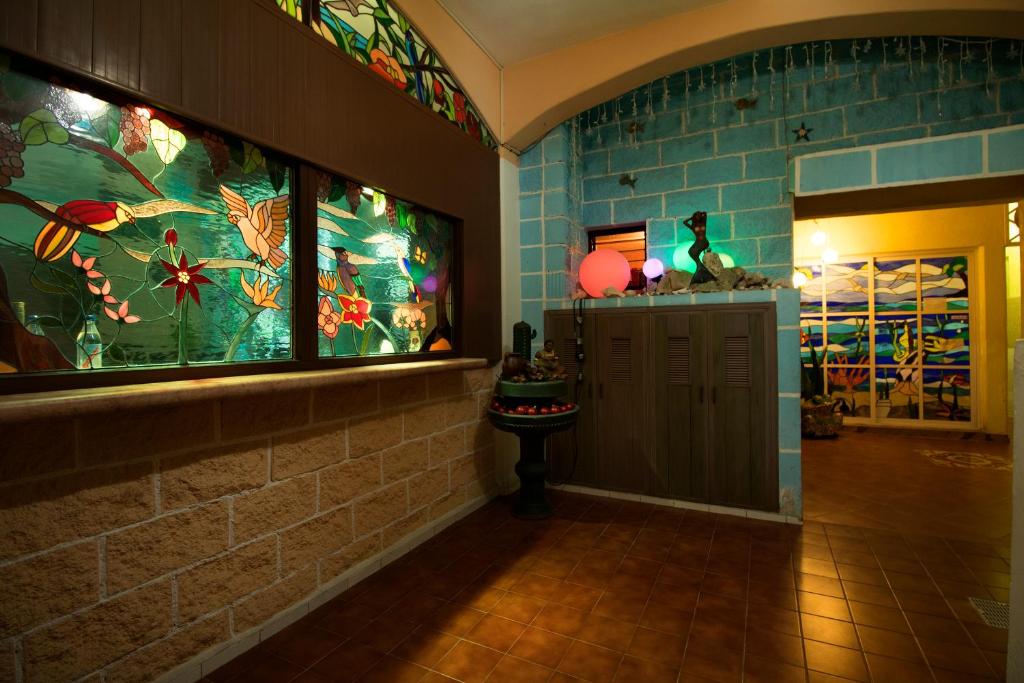 a room with stained glass windows and a hallway at Hotel Francis Arlene Adults Only in Isla Mujeres