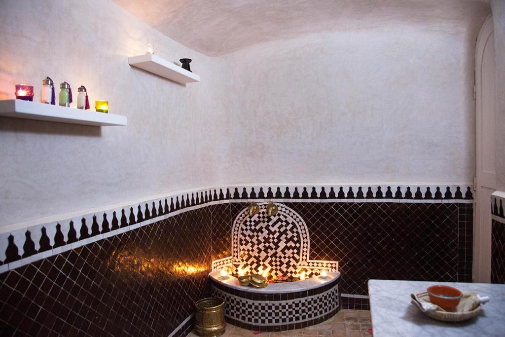 a bathroom with a tub with a fire place at Dar Tanja Boutique Hotel in Tangier