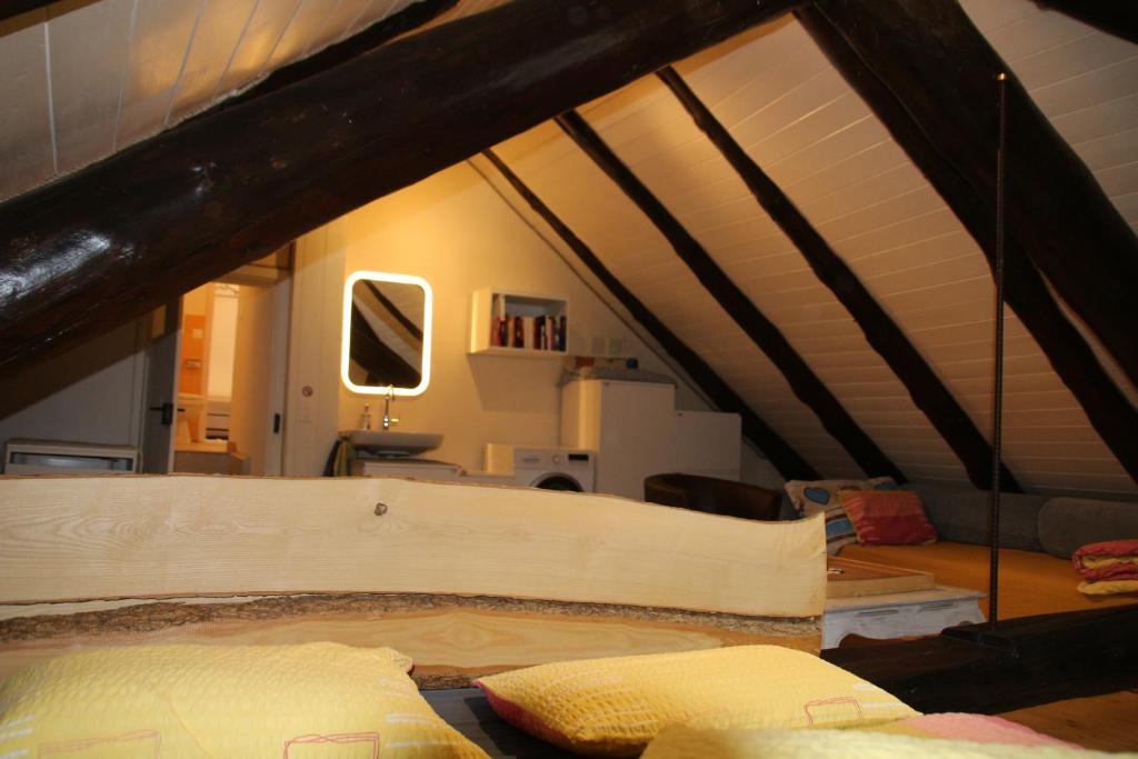 a attic room with a bed in a room at Airolo with private parking in Airolo