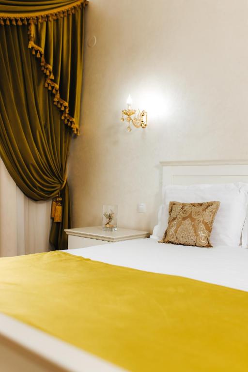 Postel nebo postele na pokoji v ubytování Hotel Evianne Boutique
