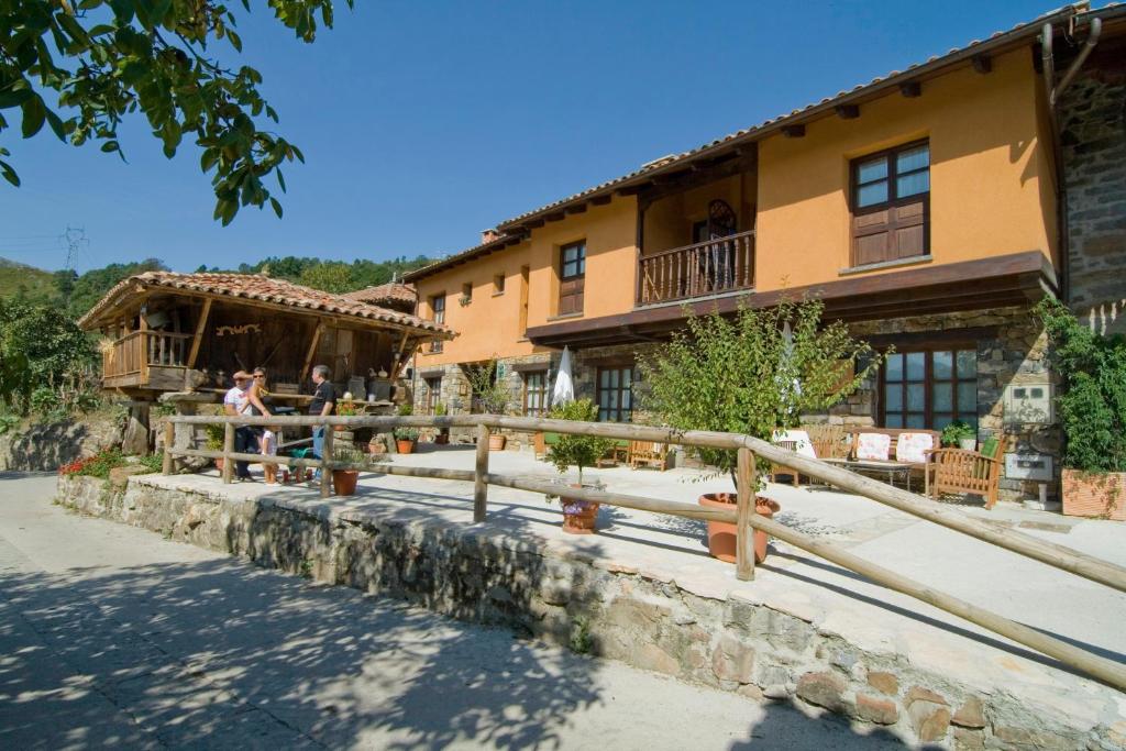 a building with people standing in front of it at Casa Les Pedroses in Campiellos