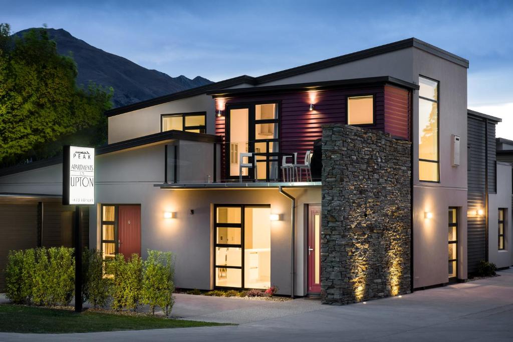 a house with lights on in front of it at Apartments on Upton in Wanaka