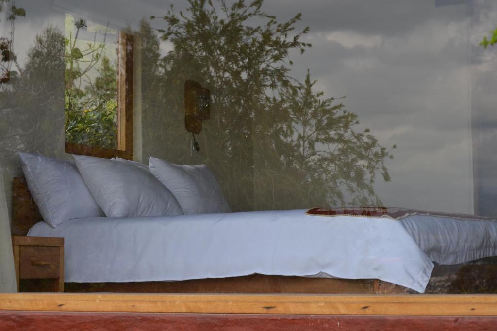 Postel nebo postele na pokoji v ubytování Ilatoa Lodge