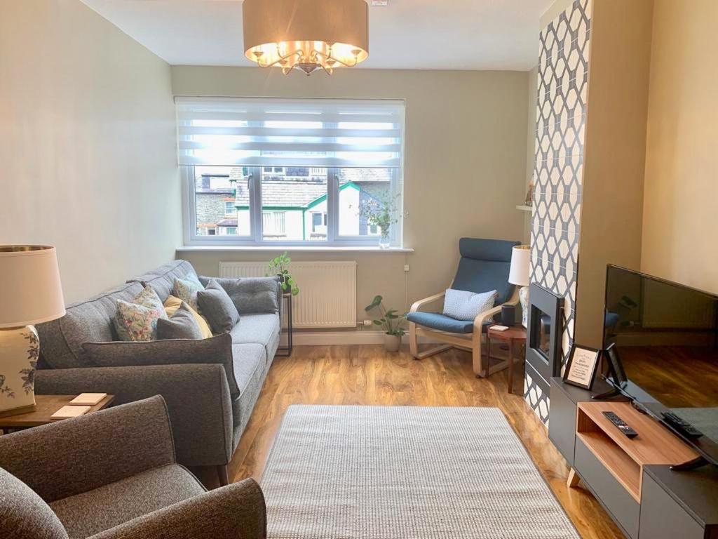 a living room with a couch and a tv at 5a Bank Street in Keswick