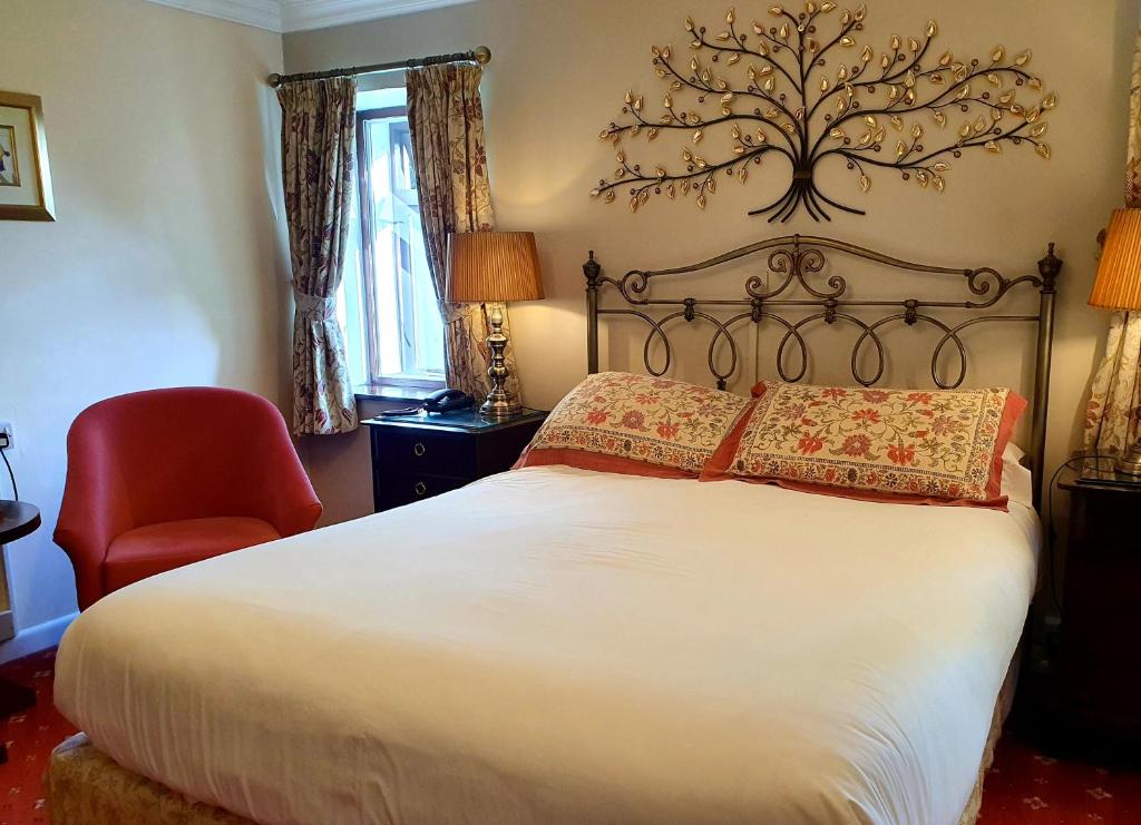 Postel nebo postele na pokoji v ubytování Stow Lodge Hotel