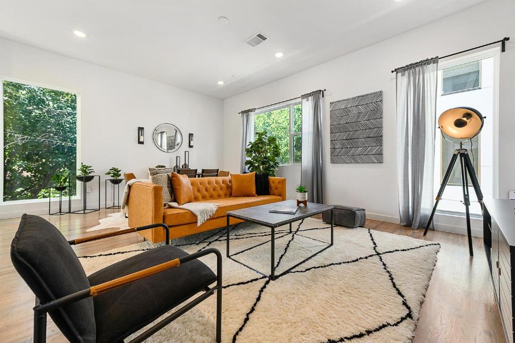 a living room with a couch and a table at Jurny - Bishop Arts District 2 Bedroom Apartments in Dallas