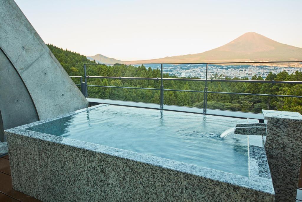 a swimming pool with a view of a mountain at Rembrandt Premium Fuji Gotenba in Gotemba
