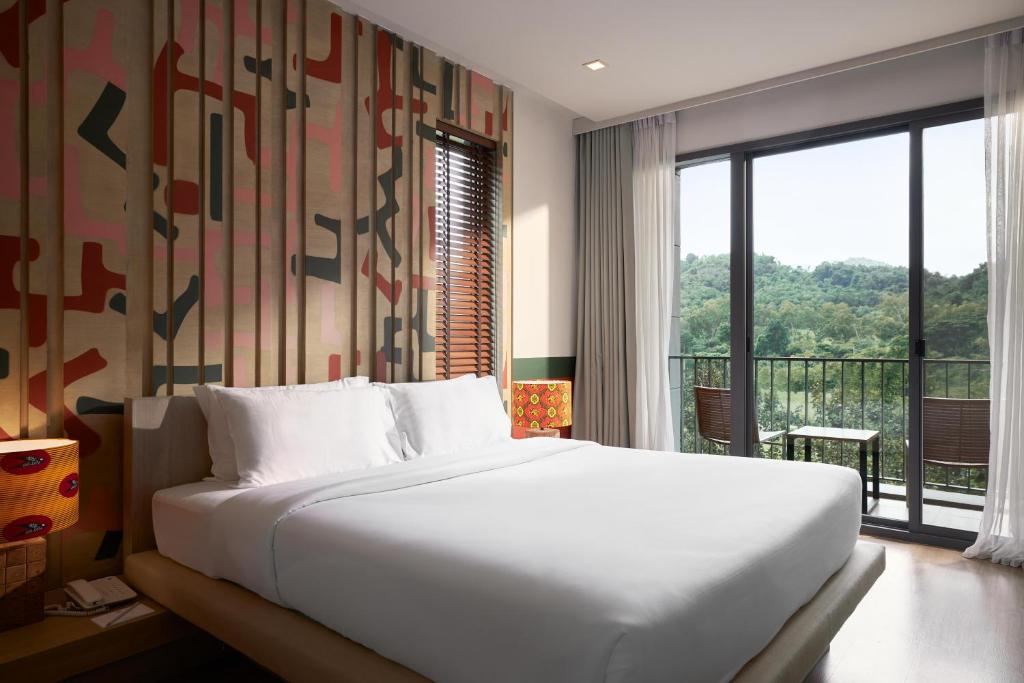 Postel nebo postele na pokoji v ubytování The Peri Hotel Khao Yai
