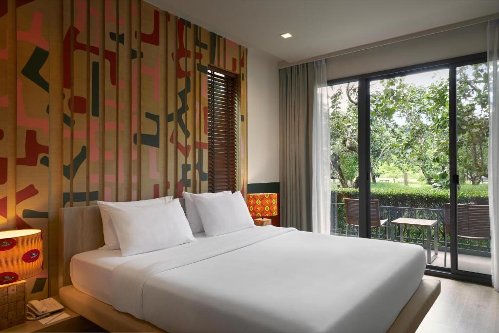 Postel nebo postele na pokoji v ubytování The Peri Hotel Khao Yai