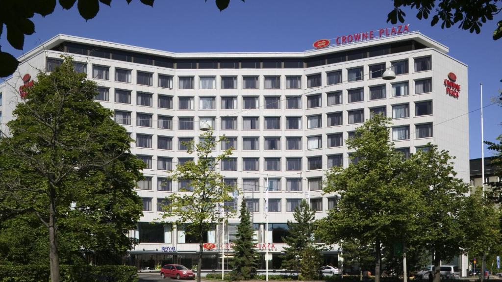 a white building with a sign on top of it at Crowne Plaza Helsinki - Hesperia, an IHG Hotel in Helsinki